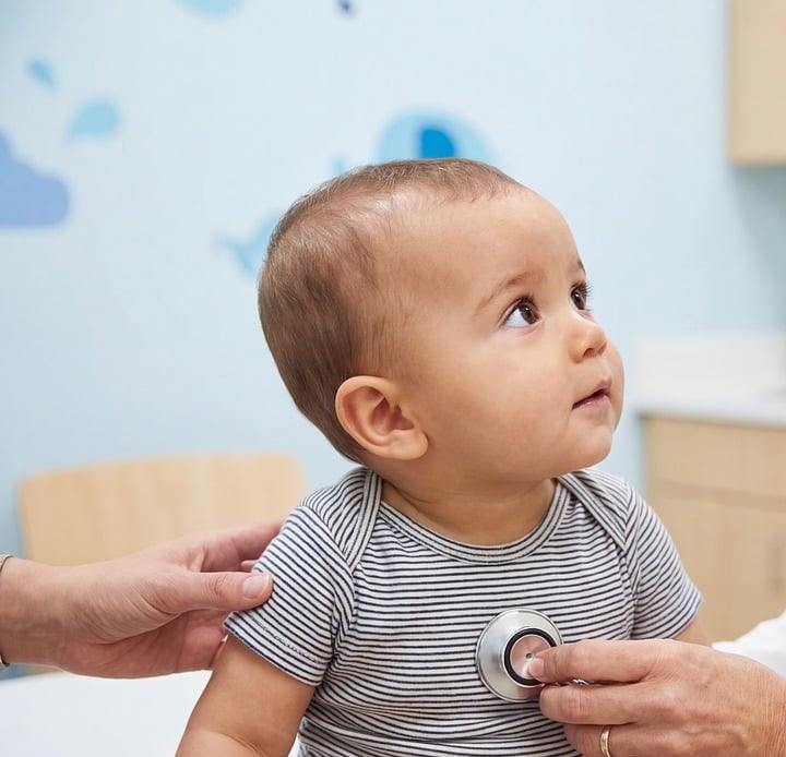 pediatrician with baby checkup care